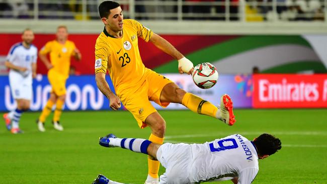 Australia's forward Tomas Rogic (L) vies for the ball with Uzbekistan's midfielder Odil Akhmedov during the 2019 AFC Asian Cup Round of 16 football match between Australia and Uzbekistan at the Khalifa bin Zayed Stadium in Al-Ain on January 21, 2019. (Photo by Giuseppe CACACE / AFP)