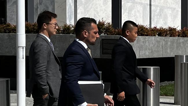 Kang Zhao (right) leaves the ACT Magistrates Court with lawyers James Maher (Middle) and Alex Cao (Left). Picture: Julia Kanapathippillai