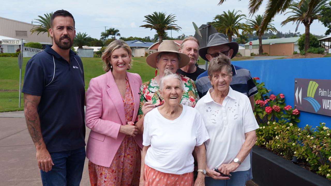 Logan Councillor Nathan St Ledger, Waterford MP Shannon Fentiman, and locals from the Palm Lake Resort Bethania, including Maureen Farrell (in straw hat).