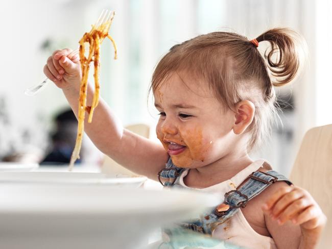 Little girl 2 years old girl eating noodles istock image