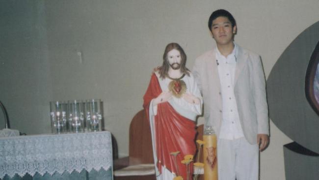 Minje Kim next to a statue of the Sacred Heart at his parish. Source: Supplied