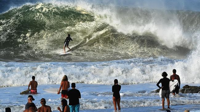 Surfers line up for a crack at the huge waves at Snapper Rocks on the Gold Coast triggered by cyclonic conditions off the Queensland coast. Picture: Lyndon Mechielsen