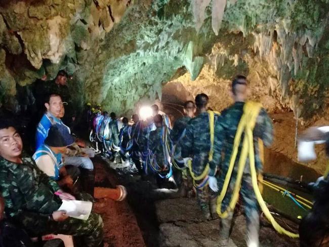 Thai soldiers carrying cables inside Tham Luang cave as the rescue operation continues. Picture: AFP