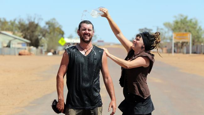 Ben Harris and Kellie Glab cool off during the 2014 heatwave in the outback town of Oodnadatta. Photo: Morne de Klerk/ The Advertiser.