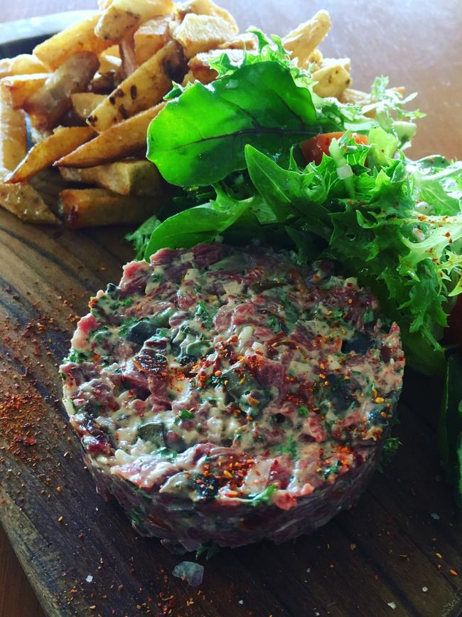 Beef tartare with hand-cut French fries and a simple green salad. Picture: SUPPLIED 