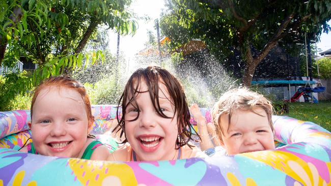 Twins Maisy and Reuben, 6, and Felix, 3, cooling off in Port Willunga. Picture: Brett Hartwig