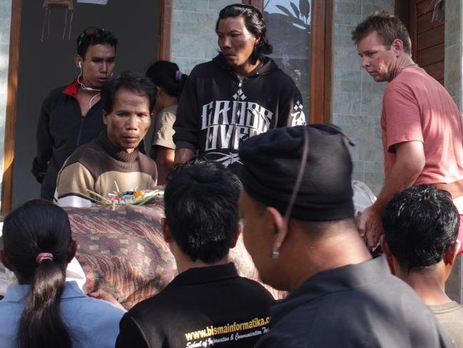 Australian Brad Williams helping the family to hold his wife's body as it arrives to their home in Nusa Penida island in Bali. Picture: Lukman S Bintoro/ News Corp