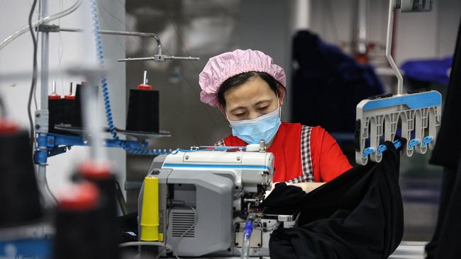 An employee works on a T-shirt production line at a clothing factory in Binzhou, in eastern China's Shandong province Picture: AFP/ China OUT