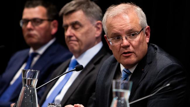 Scott Morrison speaks alongside chief medical officer Brendan Murphy, centre, and Victorian Premier Daniel Andrews on Friday. Picture: AAP