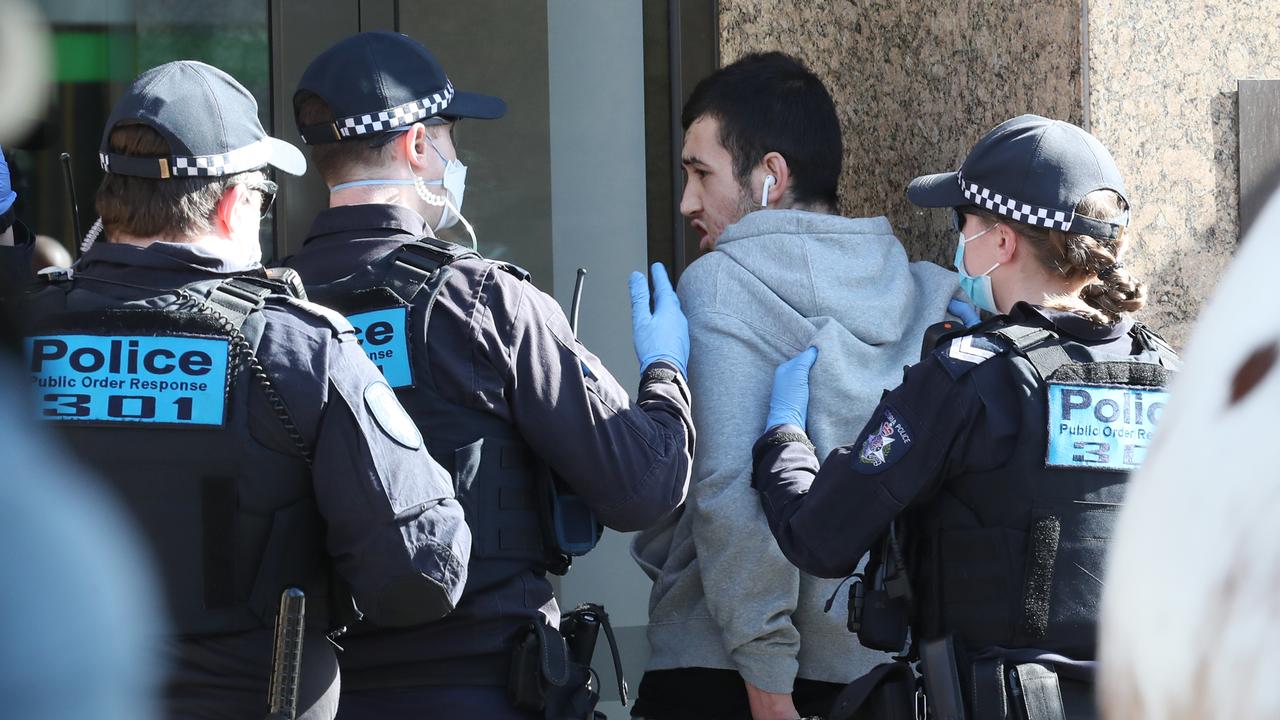 Police detain and later release a man after he was chased across St Kilda Rd in Melbourne. Picture: NCA NewsWire /David Crosling