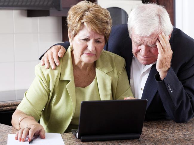 Retirees.unhappy senior couple worrying about expenses