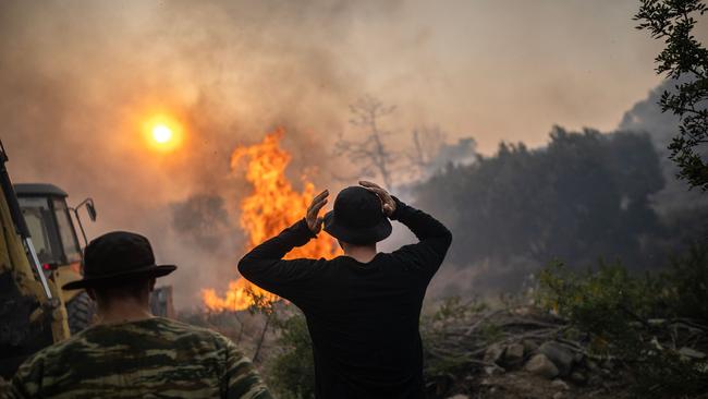 A man reacts as a fire burns into the village of Gennadi of the Greek Aegean island of Rhodes in July, 2023. Picture: AFP