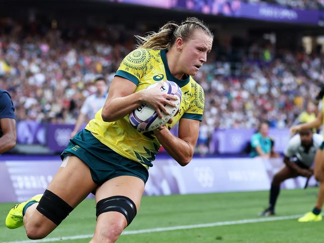 PARIS, FRANCE - JULY 30: Maddison Levi #12 of Team Australia scores her team's second try during the Women's Rugby Sevens Bronze medal match between Team United States and Team Australia  on day four of the Olympic Games Paris 2024 at Stade de France on July 30, 2024 in Paris, France. (Photo by Cameron Spencer/Getty Images)