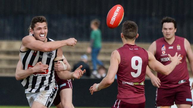 Liam Davis gets a handball away in the division one grand final last month. The star forward will be a big loss for the Falcons next season. Picture: Brenton Edwards