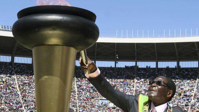 Mugabe, lights a flame at celebrations to mark 32 years of independence of Zimbabwe in 2012.