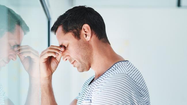 Shot of a mature businessman looking stressed out in an office