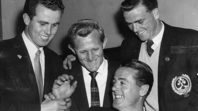 Jim Deane is congratulated by Lindsay Head, Fred A'Court and Neil Kerley after winning The Advertiser Trophy for the outstanding player in the minor round in 1957.