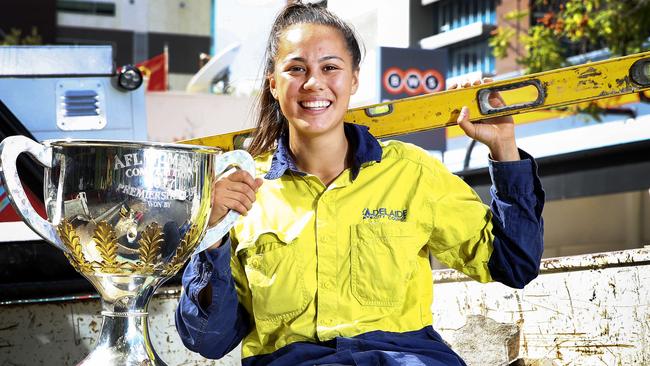 AFLW Crows premiership player Justine Mules takes the premiership trophy to work at Adelaide City Council. Picture: Sarah Reed