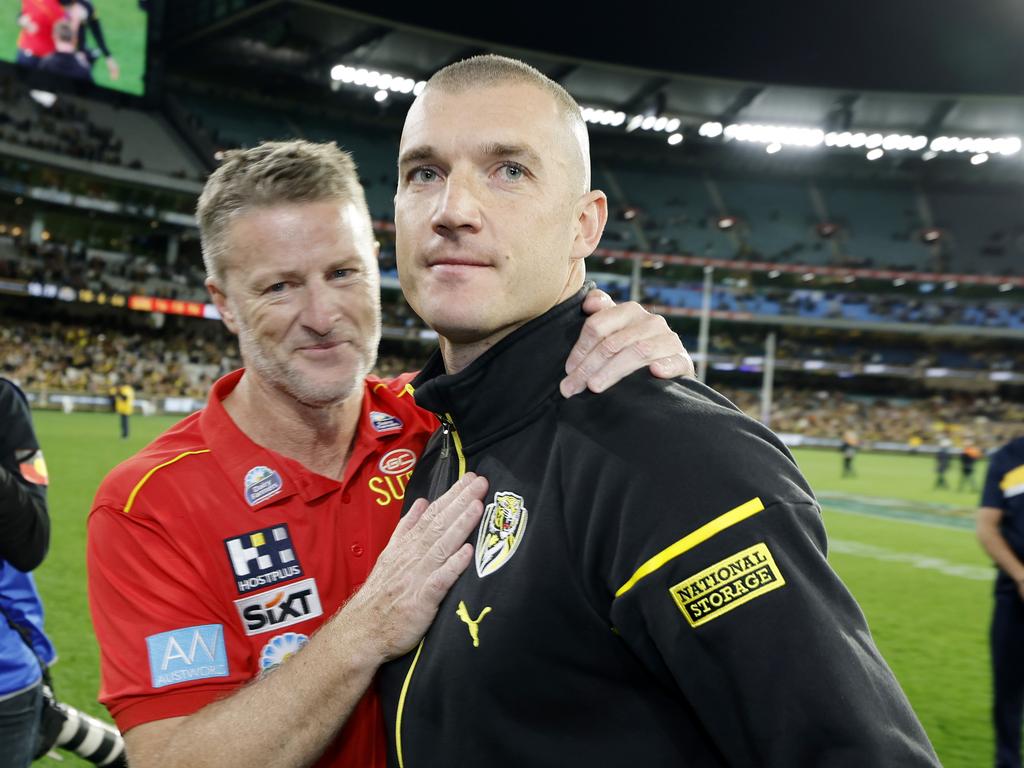 Richmond’s Dustin Martin hugs old coach Damien Hardwick on the MCG during his lap of honour. Picture: Michael Klein