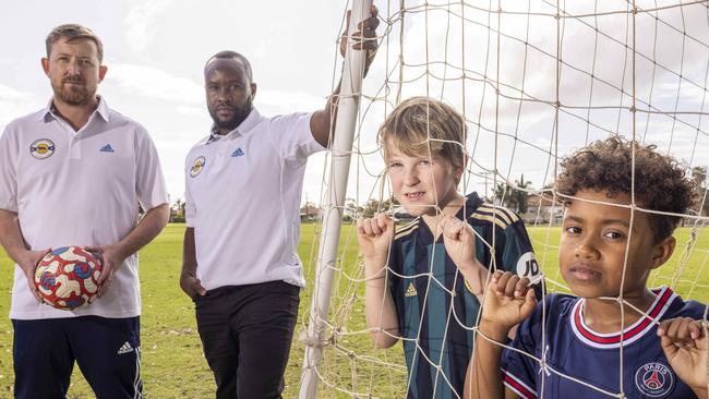 October 13 2022: Tom Quinn and Peter Mazalla with their kids, Fred (8) and Zion (7) want to give kids a chance to play soccer.   Picture: Kelly Barnes