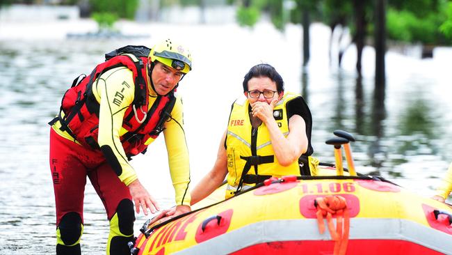 Tina Stephensen cries as she is rescued by a Swift Water Rescue Crew in Fraire Street, Hermit Park.  Picture: Zak Simmonds