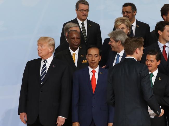 President Trump is left hanging at the group photo before French President Macron takes his place. Picture: Sean Gallup/Getty Images.