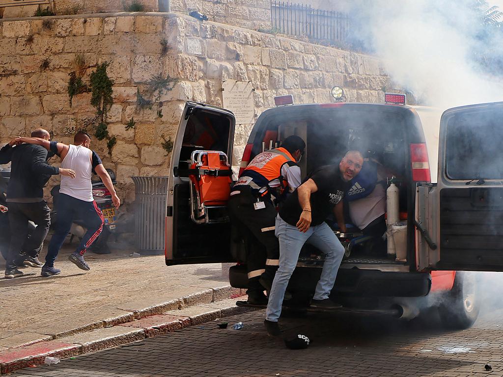 Palestinian medics evacuate wounded protesters as more than 300 were thought injured in clashes on Monday. Picture: Emmanuel Dunand / AFP