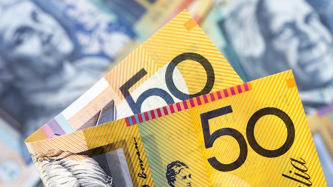 Australian money background.  Focus on foreground, blurred faces beneath. Fifty dollar notes generic