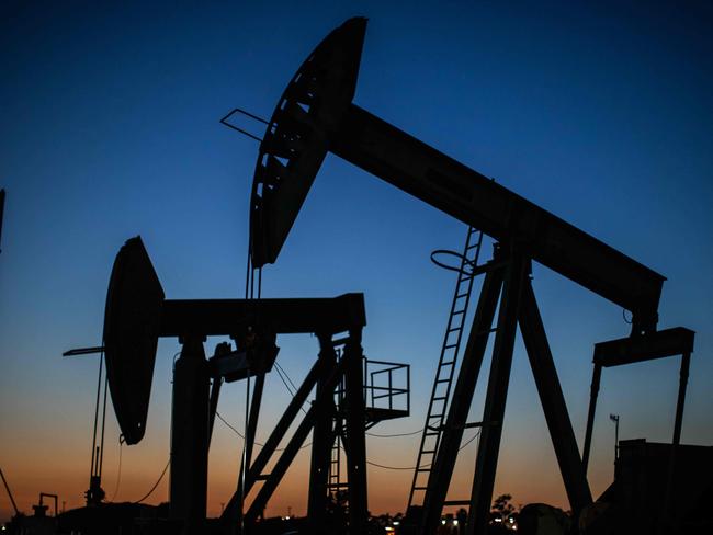 Oil pumpjacks operate at dusk Willow Springs Park in Long Beach, California on April 21, 2020, a day after oil prices dropped to below zero as the oil industry suffers steep falls in benchmark crudes due to the ongoing global coronavirus pandemic. - President Donald Trump on April 21 ordered his administration to come up with a plan to aid US oil companies struggling with a massive supply glut and record-low crude prices. "We will never let the great US Oil & Gas Industry down," Trump tweeted. (Photo by Apu GOMES / AFP)