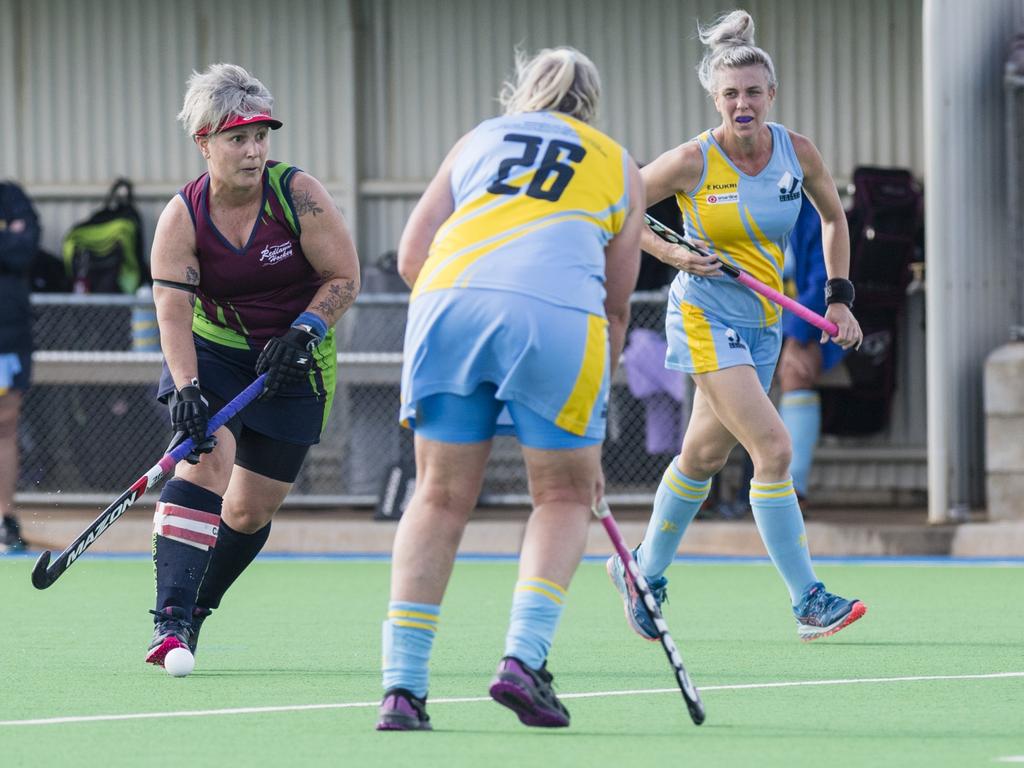 Redlands 1 captain Petra West (left) on the move against Cairns 1.