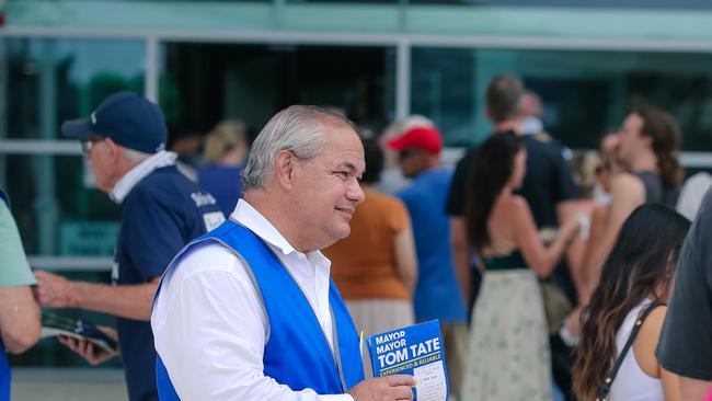 Mayor Tom Tate hands out how to vote material at the Bundall polling booth at the council chambers. Picture: Glenn Campbell