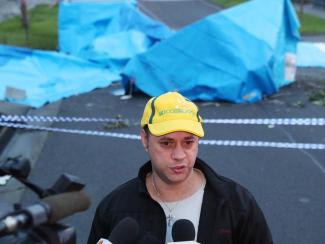 Local resident Vlad talks to the media in front of his house where the wreckage of a light plane is seen in Scarlet Street. Picture: AAP Image/David Crosling