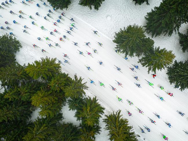 A Shoal of Colourful Fish by Jacek Deneka, Drone Awards Photographer of the Year 2019 winner. The photo shows cross-country skiers during the Bieg Piastów competition in Poland. From the sky, the skiers look like a shoal of colourful fish floating among coral reefs. Picture: Jacek Deneka/2019 Drone Awards