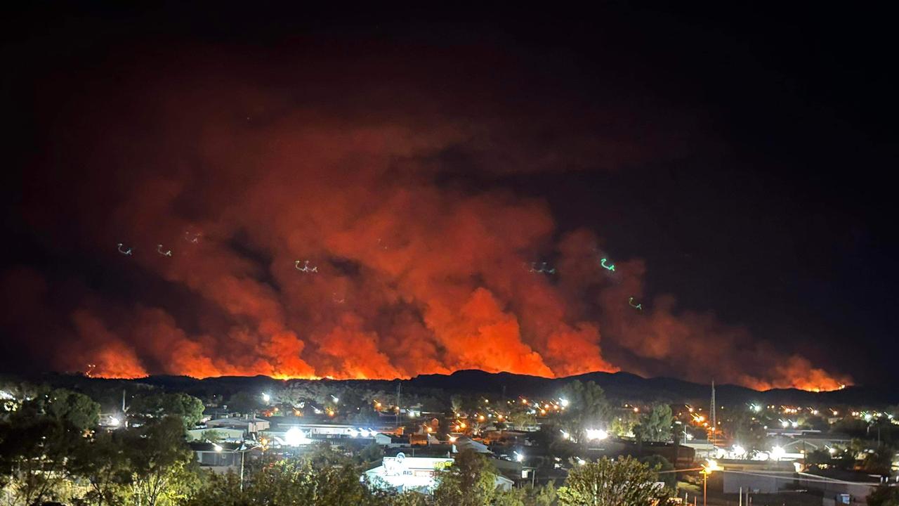 The bushfire lit the Alice Springs sky orange on Friday night. Picture: Naomi Melick and Lilly Potger