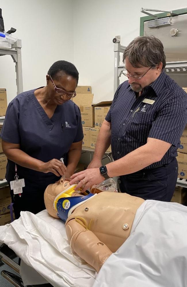 CRANAplus chair and Tennant Creek Hospital staffer John Wright performs air­way train­ing with Vio­let Kud­zot­sa.