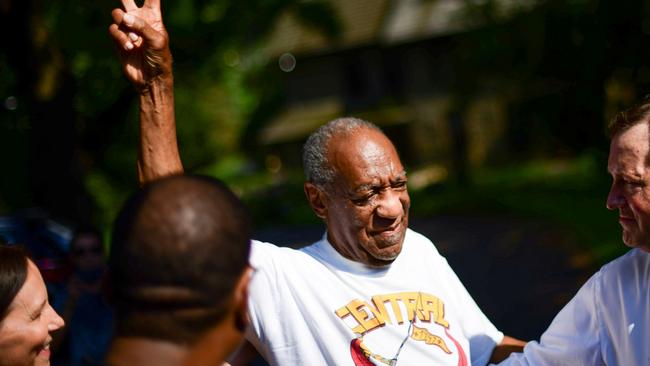 Bill Cosby flashes a "V" sign as he is welcomed outside his home after Pennsylvania's highest court overturned his sexual assault conviction and ordered him released from prison immediately. Picture: Reuters