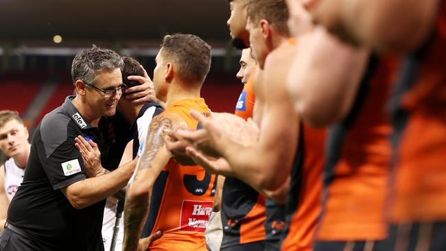 Cameron stops to embrace Zac Williams, who played with the Giants before joining the Blues and could be out of action with a torn achilles. Picture: Mark Kolbe/Getty Images