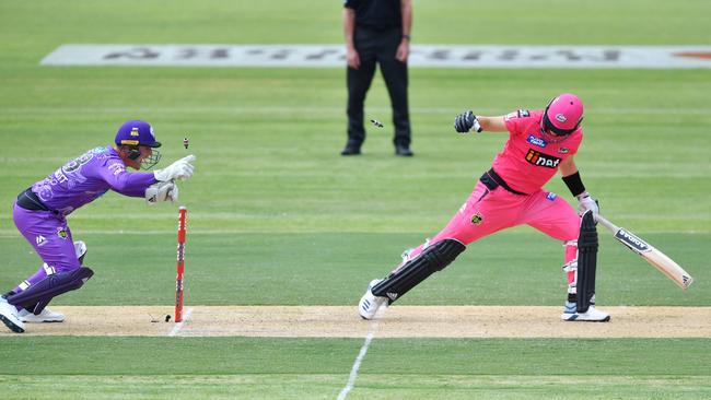 Hobart’s Ben McDermott stumps Sydney’s Sean Abbott during the Big Bash League match in Alice Springs on Friday. Picture: AAP/DAVID MARIUZ