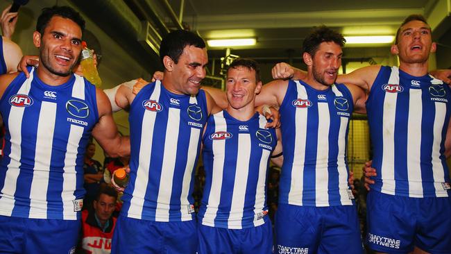 (From left) Daniel Wells, Lindsay Thomas, Brent Harvey, Jarrad Waite and Drew Petrie sing the song after a win.