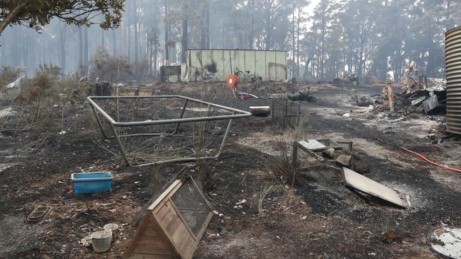 The remains of a trampoline in the yard of a home lost to fire near the Huon Highway at Geeveston. 