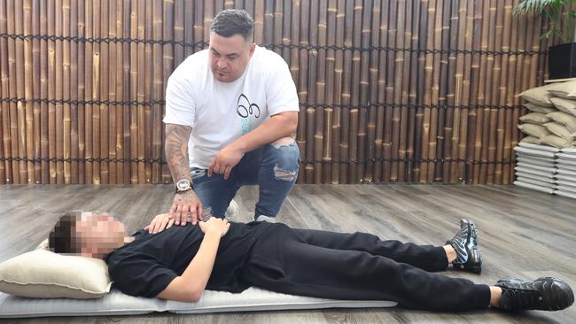 Esuarve founder Joseph Te Puni-Fromont at his Ormeau base helping a client with breathing excercises in the meditation room. Picture: Glenn Hampson.