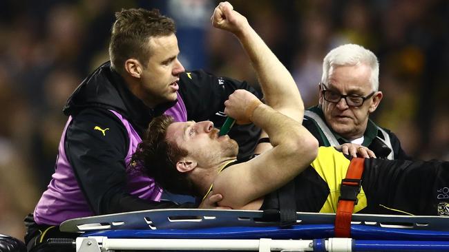 Reece Conca gestures to the crowd as he is cheered off the field.