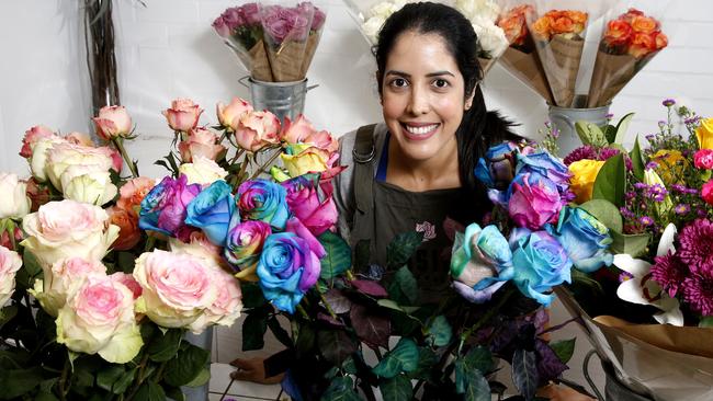 Cecilia Suarez from Rosita Flowers at Pacific Fair with some of the Rainbow roses. Picture: Jerad Williams