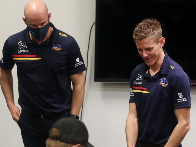 AFL - Crows training + Press Conference - Thursday, 19th August, 2021 - at the Adelaide Oval.  David Mackay shakes the hand of Lachlan Murphy after his official retirement press conference - senior coach Matthew Nicks standing along side of him Picture: Sarah Reed