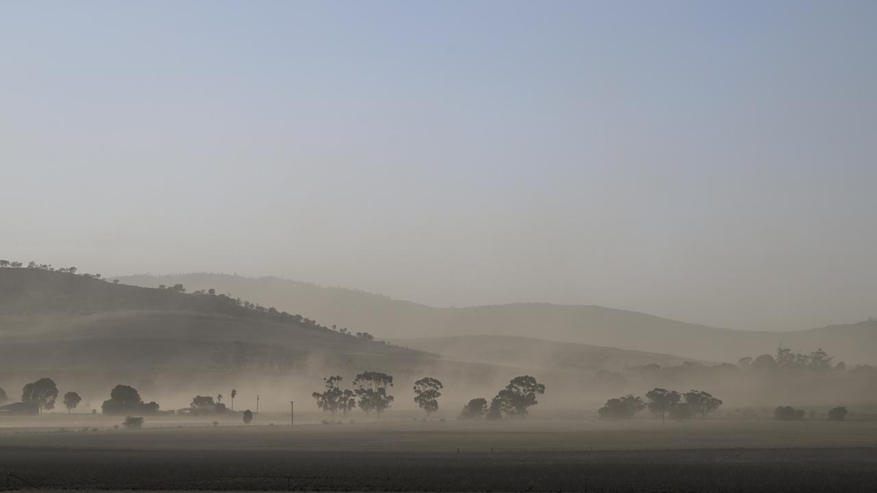 High winds blow up the dust in a paddock near Manoora. Picture: Mark Brake
