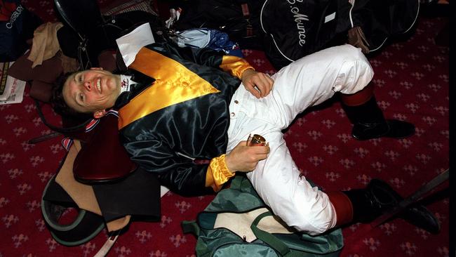 Jockey Chris Munce on floor of jockey's room after he rode Jezabeel to victory in 1998 Melbourne Cup at Flemington.