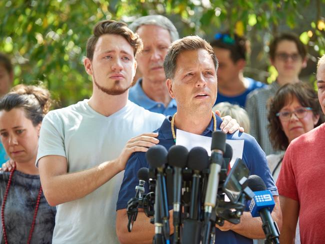 Don Damond is comforted by his son Zach. Picture: Jules Ameel