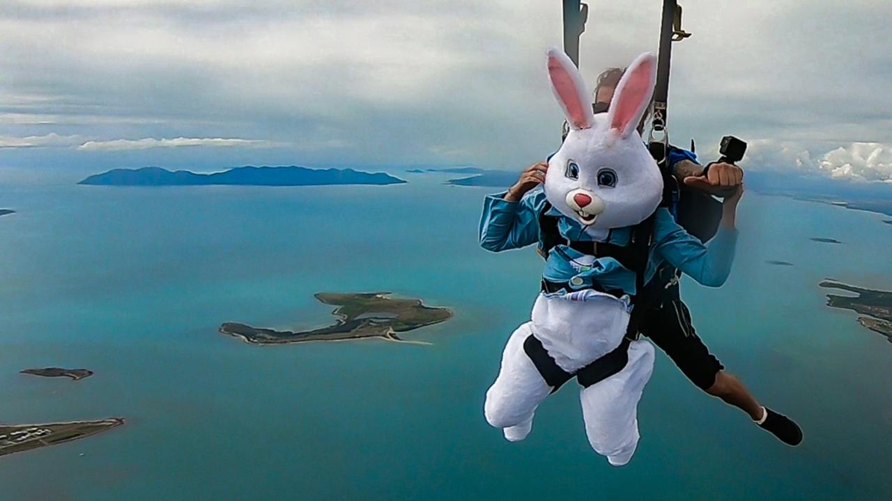 The Easter bunny skydives over the Whitsunday Islands, Queensland, preparing to land on Queens Beach in April 2019.