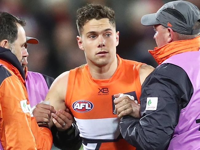 CANBERRA, AUSTRALIAN CAPITAL TERRITORY - AUGUST 11:  Josh Kelly of the Giants is assisted after a sling tackle from Taylor Walker of the Crows during the round 21 AFL match between the Greater Western Sydney Giants and the Adelaide Crows at UNSW Canberra Oval on August 11, 2018 in Canberra, Australia.  (Photo by Matt King/AFL Media/Getty Images)