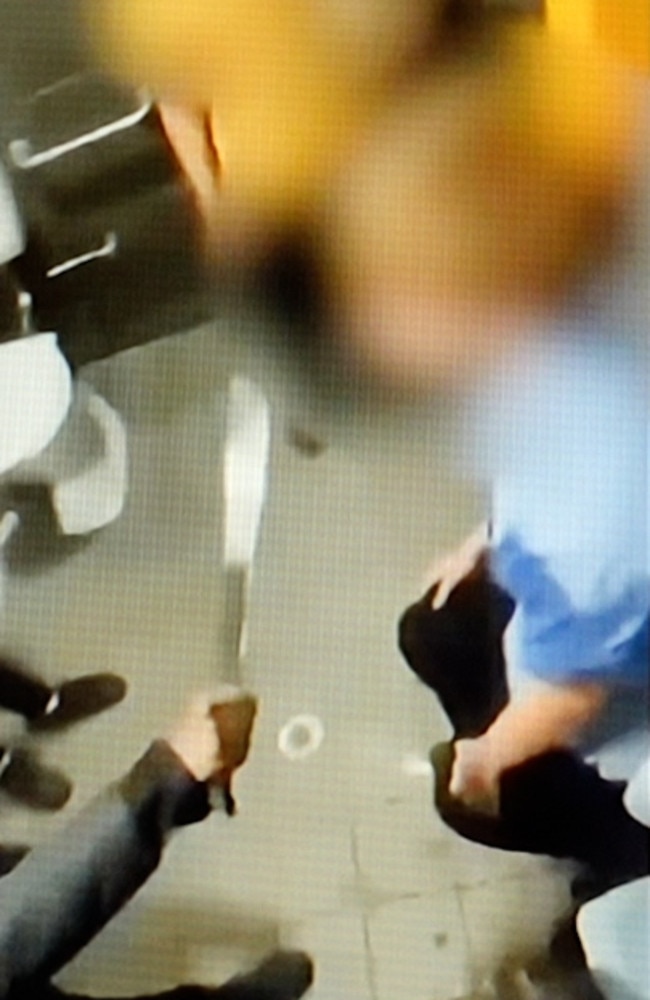 The boy appears to bend down as the blade of a machete is pushed to his throat. Picture: Supplied